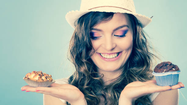 istock Smiling summer woman holds cakes in hand 1068041772
