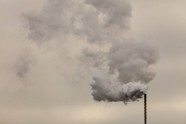 istock Smoke from chimney on dark cloudy sky 1068042328