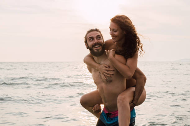 istock Man looking at the woman sitting on his back 1068044394