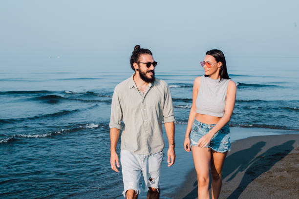 istock Happy couple walking down the beach 1068048508