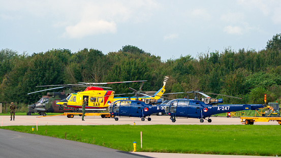 Leeuwarden, Netherlands - Sep 17, 2011: Royal Netherlands Air Force Bell 412, Alouette III and Cougar helicopter line-up on Leeuwarden airbase