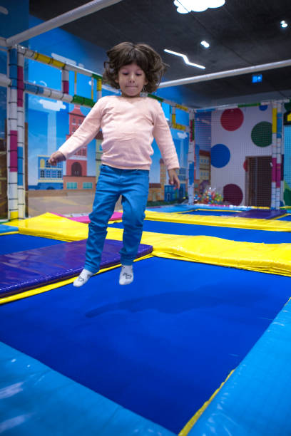 istock Cute little boy jumping on playground trampoline. 1068050318