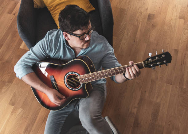 istock Young male playing guitar 1068052592