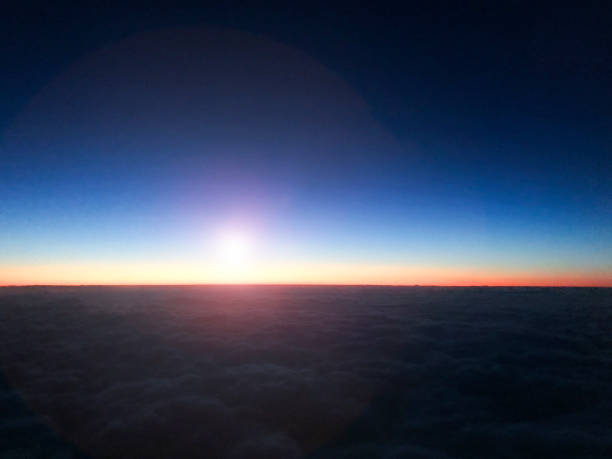 istock Airplane in flight at sunrise. 1068053896