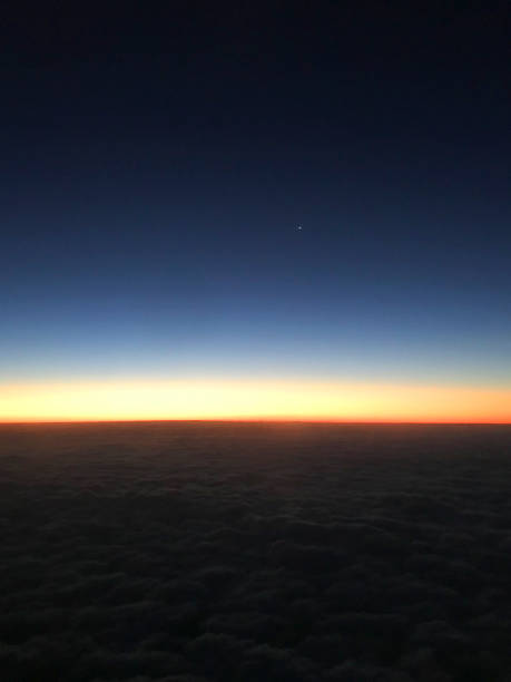 istock Airplane in flight at sunrise. 1068054262