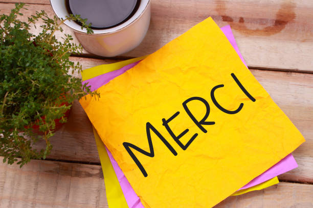 Merci, Motivational Words Quotes Concept Merci, French thank you words letter, written on piece of memo paper. Motivational business typography quotes concept french language photos stock pictures, royalty-free photos & images
