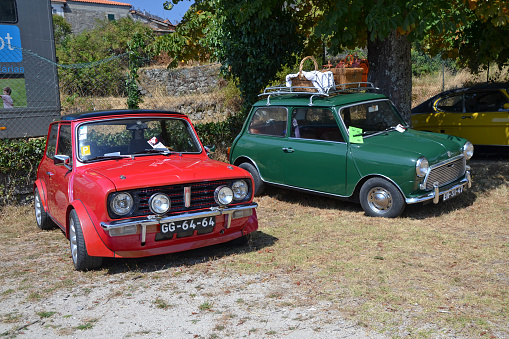 Caramulo, Portugal – September, 7, 2013: Classic Mini 1275 GT and Mini on the parking during the meeting of classic cars friends. The first Mini is cult car today.