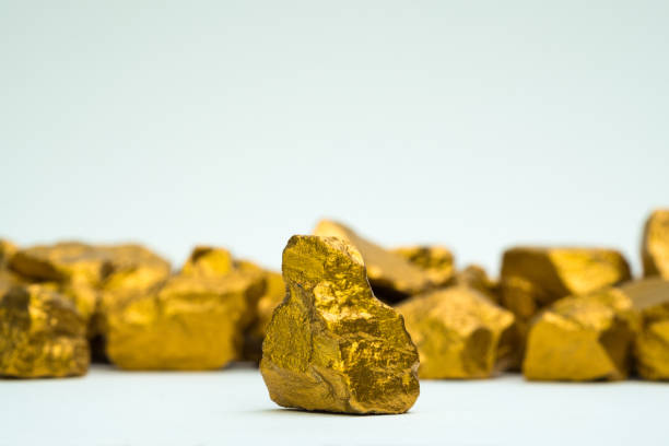 A pile of gold nuggets or gold ore on white background, precious stone or lump of golden stone, financial and business concept. A pile of gold nuggets or gold ore on white background, precious stone or lump of golden stone, financial and business concept idea. goldco precious metals complaints stock pictures, royalty-free photos & images