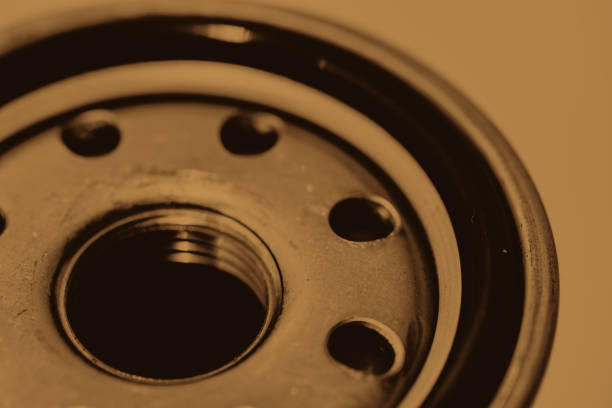 istock Monochrome background image of oil filter close up. Artwork from auto part in macro photography in sepia tones. 1068073904