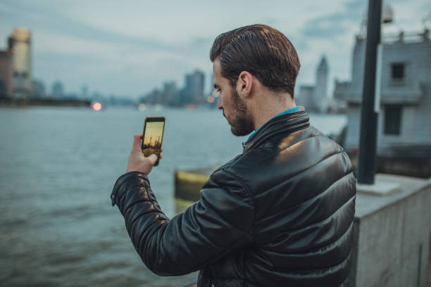 istock Young man taking photo with phone 1068108224