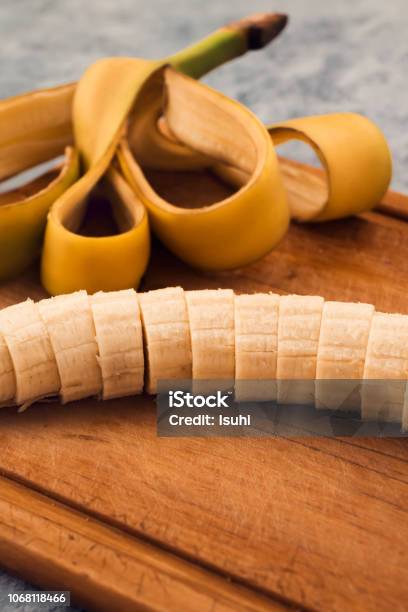 Ripe Banana Without Peel Cut Into Round Slices On A Wooden Background Stock Photo - Download Image Now