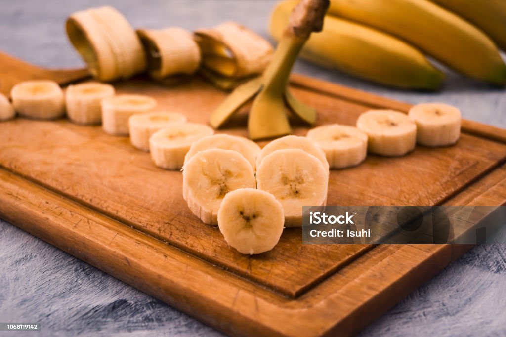 Sliced round pieces of ripe banana beautifully laid on wooden background. Backgrounds Stock Photo