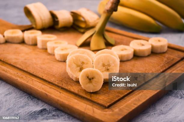 Sliced Round Pieces Of Ripe Banana Beautifully Laid On Wooden Background Stock Photo - Download Image Now