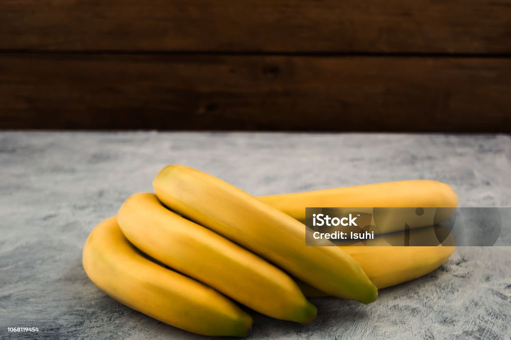 Tropical ripe bananas on wooden background, copy space. Backgrounds Stock Photo