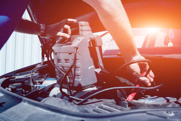 istock Accumulator charging. Hands and terminal. Car repair. 1068124874