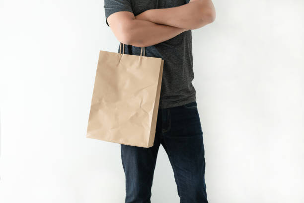 istock Consumer pack product Man shows bag mock up show 1068143836