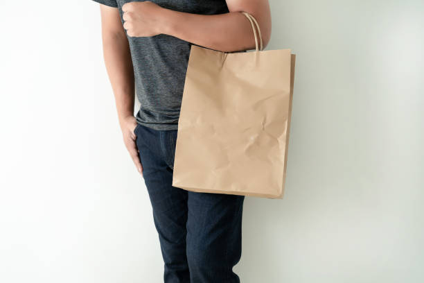 istock Consumer pack product Man shows bag mock up show 1068144090