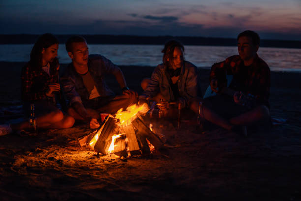 istock young friends have picnic with bonfire on the beach 1068161218