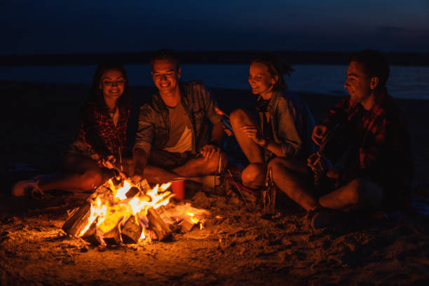 istock young friends have picnic with bonfire on the beach 1068163522