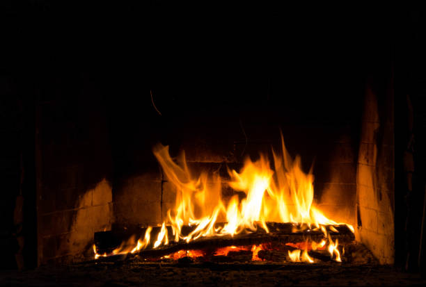 istock Flickering fire flames on black background in a fireplace 1068195600