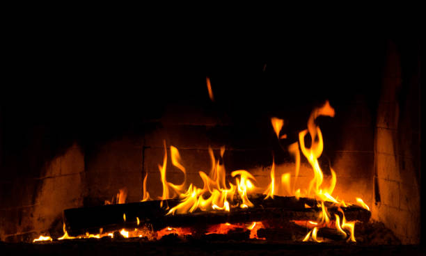 istock Flickering fire flames on black background in a fireplace 1068195682