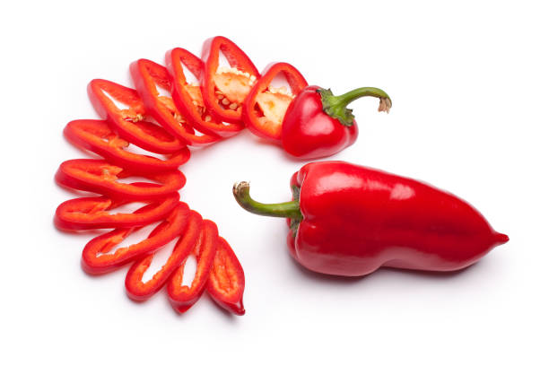 istock Red pepper whole and red pepper sliced with rings on a white background isolated top view 1068199972