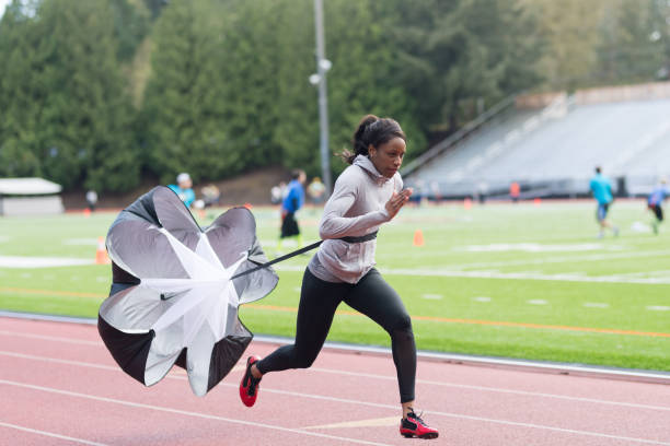 istock Female track athlete training at stadium 1068209704