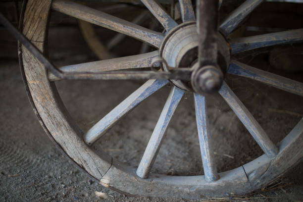 Color image of a old wooden cart wheel.