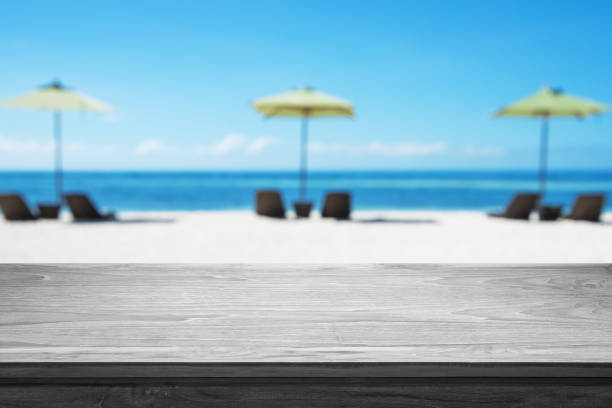 istock Empty Wooden Table With Tropical Paradise Beach Background 1068238528