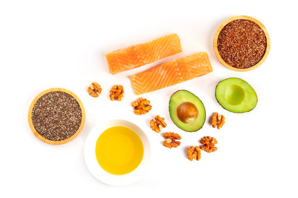 an overhead photo of the ingredients of a healthy omega 3 diet. salmon, avocado, nuts, chia and flax seeds, shot from the top on a white background with a place for text - nutritional supplement salmon food flax imagens e fotografias de stock