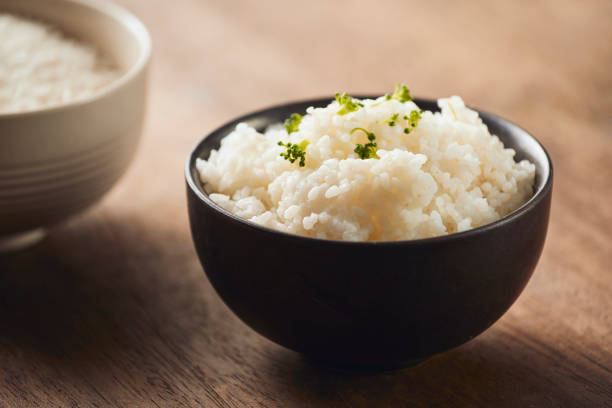 istock cooked jasmine rice and raw organic rice 1068243684