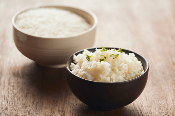 istock cooked jasmine rice and raw organic rice 1068243692