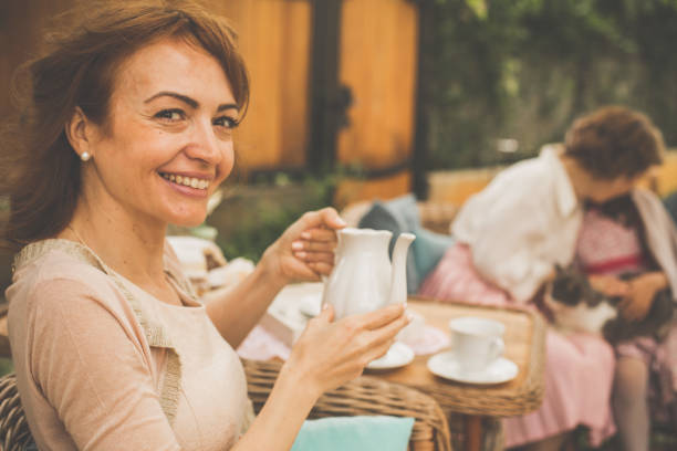 istock Woman holding a porcelain teapot 1068248590