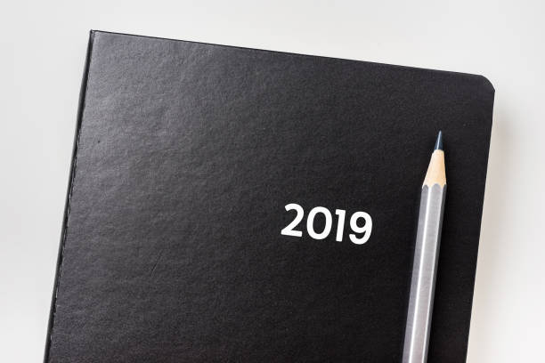istock top view of black notebook with word 2019 1068250426