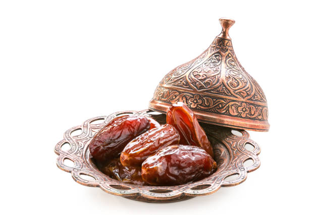 istock Plate of pitted dates isolated on a white background. 1068250826