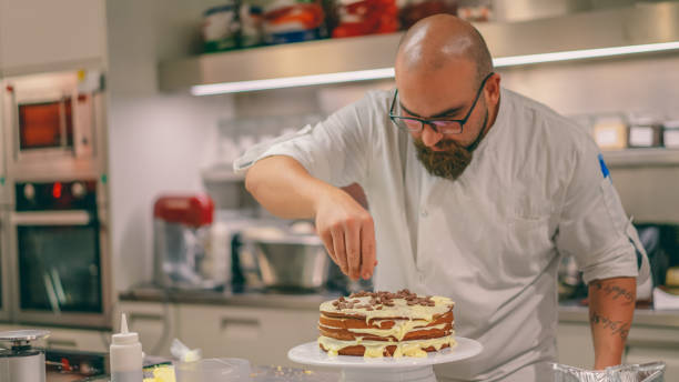 istock Chef is putting piece of chocolate on pastry 1068251506