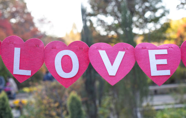 istock Love message written. Hearts hanging on a string. Love text 1068255992