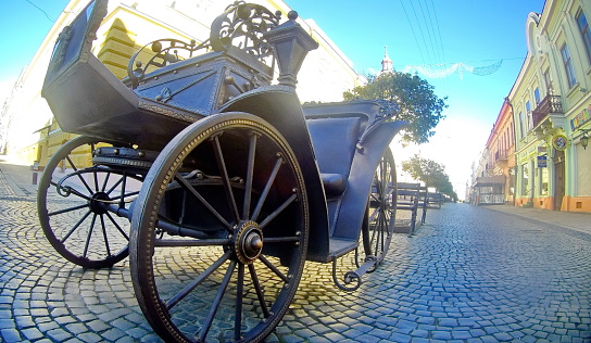 CHERNOIVTSY, UKRAINE - APRIL 16, 2017:: iron coach like architecture element upon street The coach of forged parts. Wrought iron decorative items.