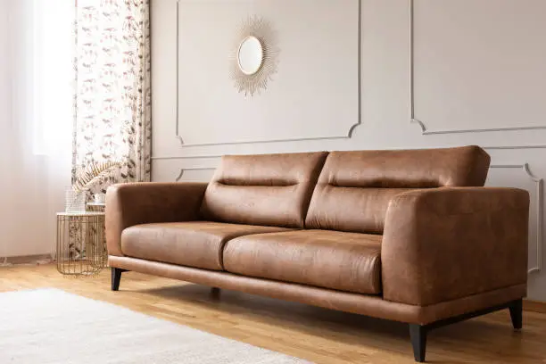 Photo of Real photo of a leather couch in a living room interior
