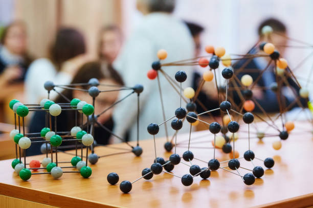 istock Students sit in the classroom and listen to a lecture in science. Plastic molecular educational model. Soft focus background image 1068259346