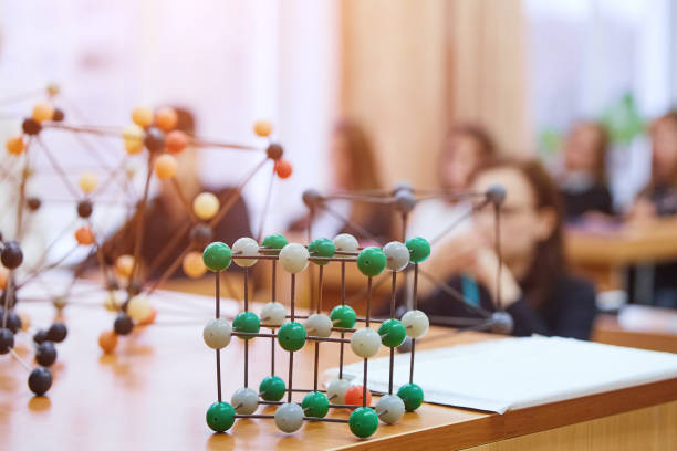istock Students sit in the classroom and listen to a lecture in science. Plastic molecular educational model. Soft focus background image 1068259368