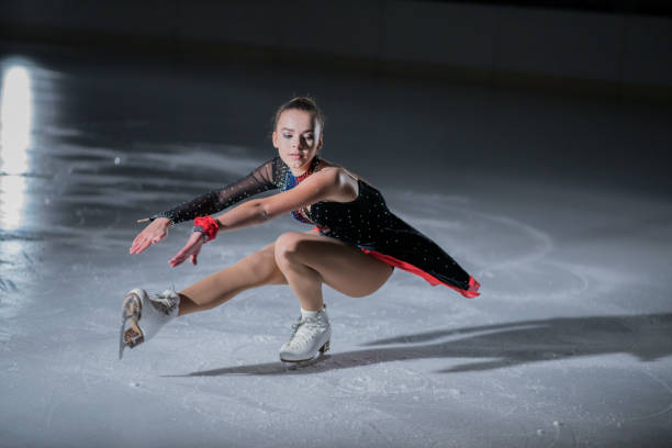 istock Young ice skater is making spins on the ice rink 1068261586