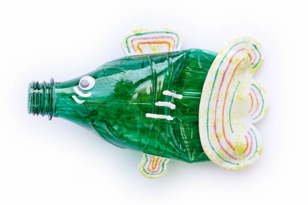 istock Plastic bottle recycled in a fish figure. Reuse garbage 1068264234