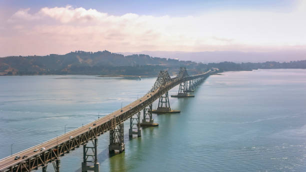 Aerial view of Richmond-San Rafael Bridge during sunrise Aerial shot of the Richmond-San Rafael Bridge in San Francisco Bay, California, USA. san rafael california stock pictures, royalty-free photos & images