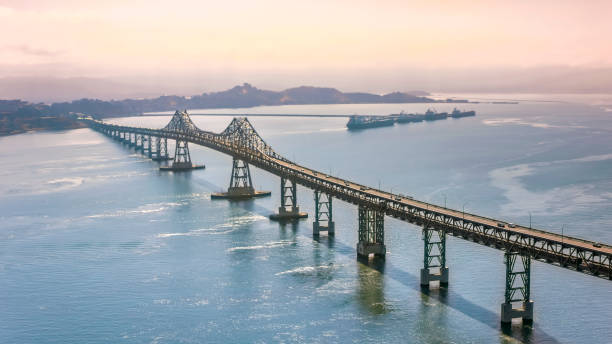 Aerial view of Richmond-San Rafael Bridge during sunrise Aerial shot of the Richmond-San Rafael Bridge in San Francisco Bay, California, USA. san rafael california stock pictures, royalty-free photos & images