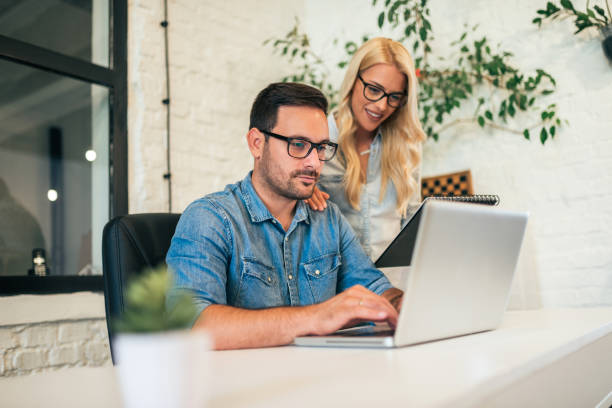 istock Two young business people working together on a project. 1068271950
