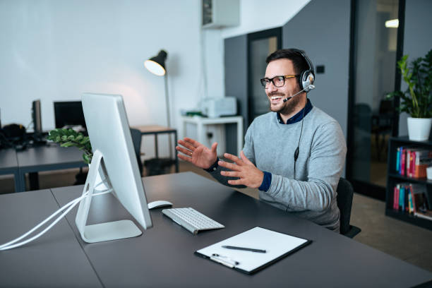 istock Happy handsome operator with headset working in the modern office. 1068273826