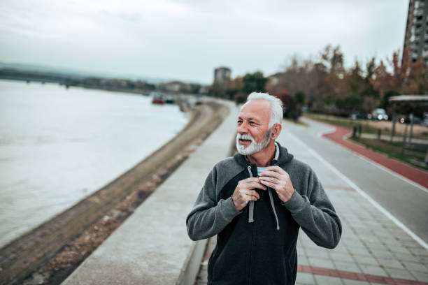 istock Active sporty senior man walking by the river. 1068274528