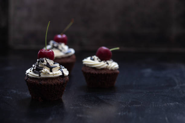 istock chocolate cake with cream and cherry 1068276640