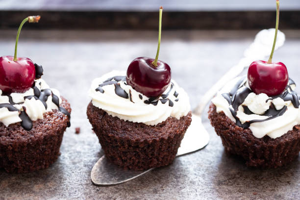 mini chocolate cakes with icing on the cake stock photo
